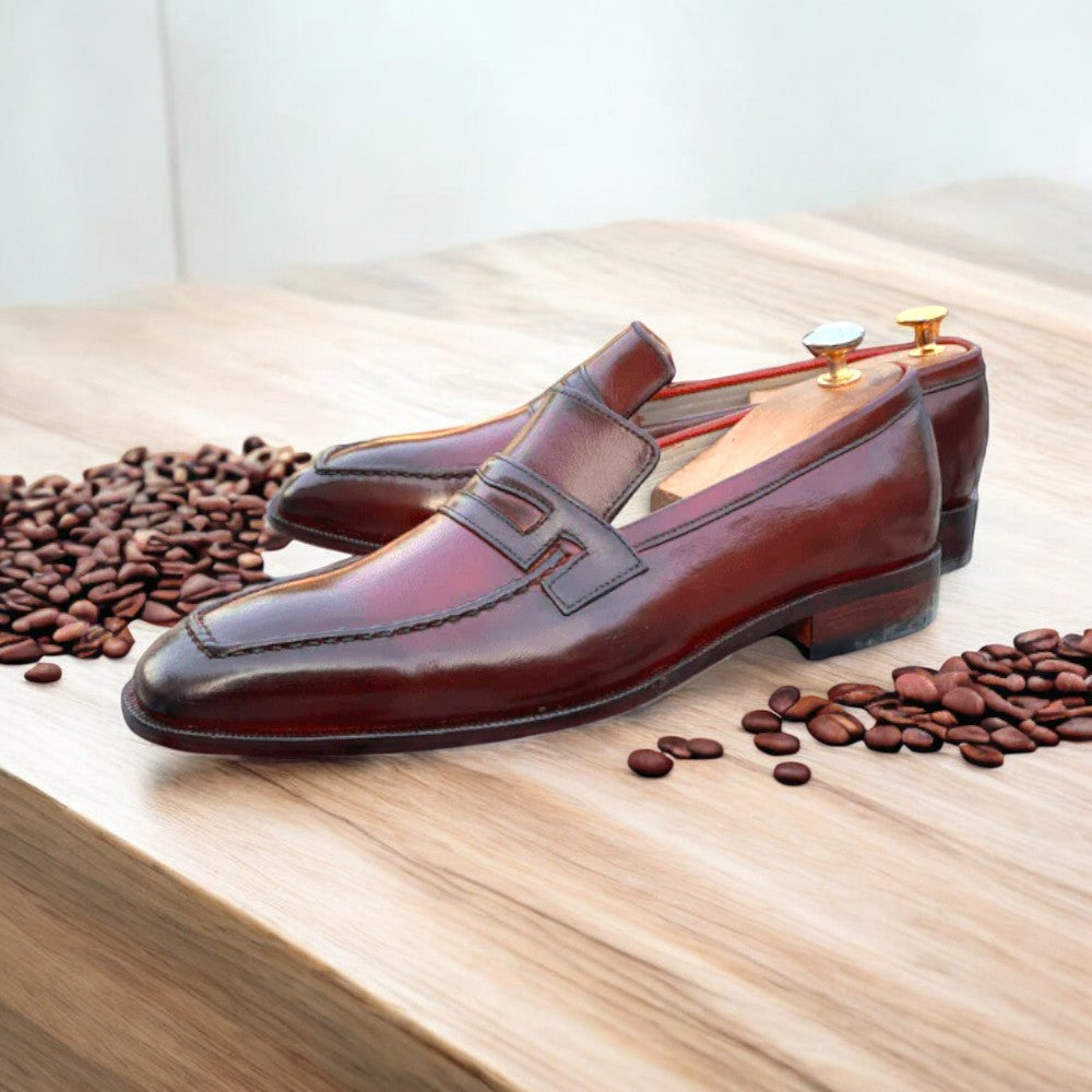 Handmade burgundy leather slip-on loafers for men, showcasing a stylish and casual design.