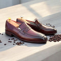 Handmade burgundy leather slip-on loafers for men, showcasing a stylish and casual design.