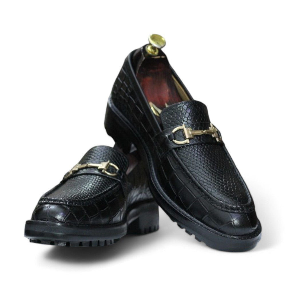 Black Alligator Loafer Shoes displayed on a wooden surface, showcasing their sleek design and elegant texture.